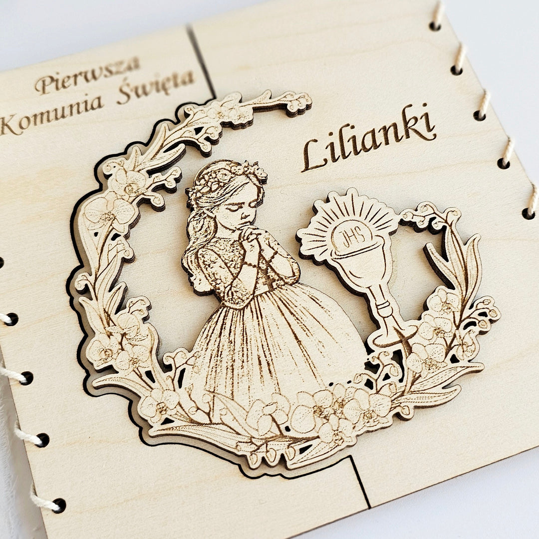 a wooden frame with a carved illustration of a young girl in a gown, surrounded by floral elements.