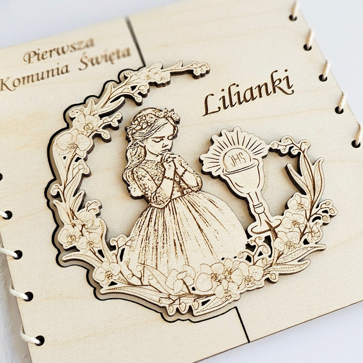 a wooden frame with a carved illustration of a young girl in a gown, surrounded by floral elements.