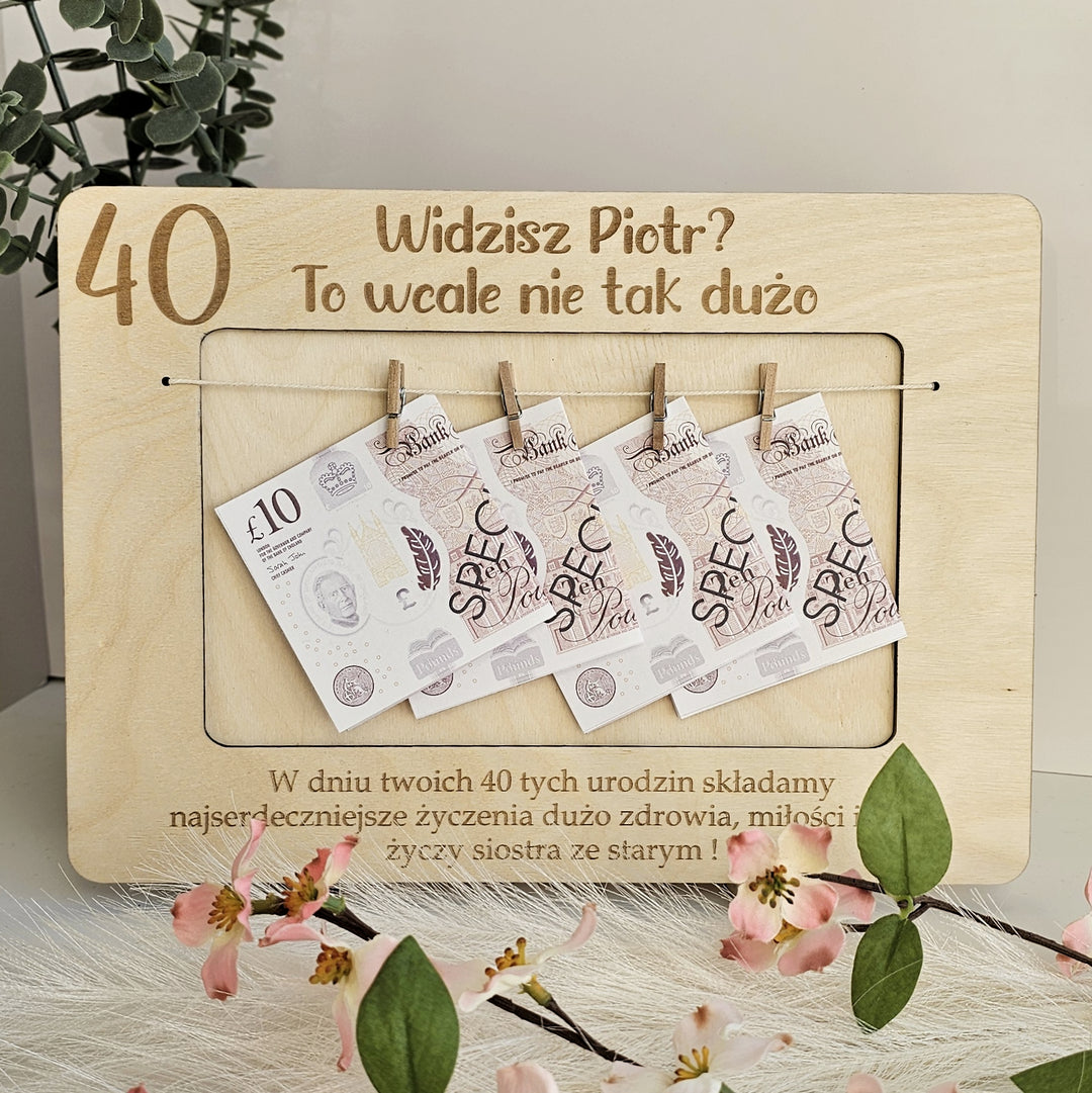 A wooden frame with a collection of Polish banknotes hanging from it, along with a message in Polish.