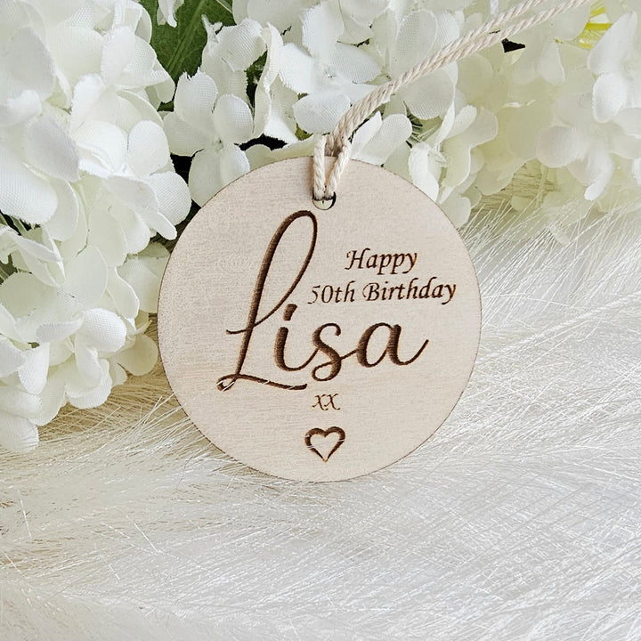 a wooden birthday ornament with a name on it