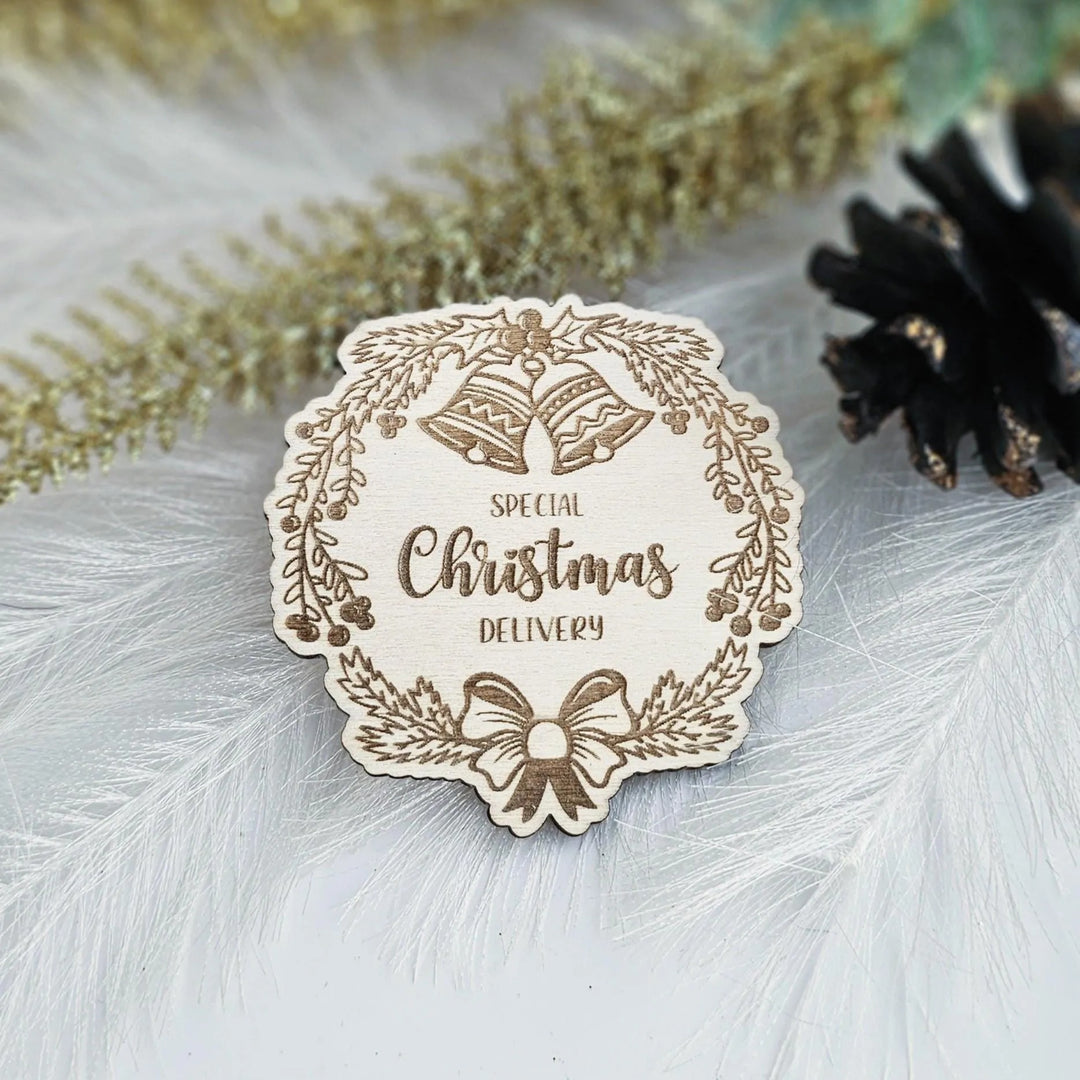 A wooden Christmas card with the text "SPECIAL CHRISTMAS DELIVERY" is displayed on a white background, surrounded by decorative elements such as feathers and a pine cone.