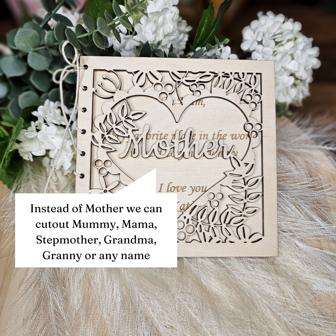 A wooden card with a heart-shaped cutout in the center, surrounded by white flowers, and a message that reads "I love you".