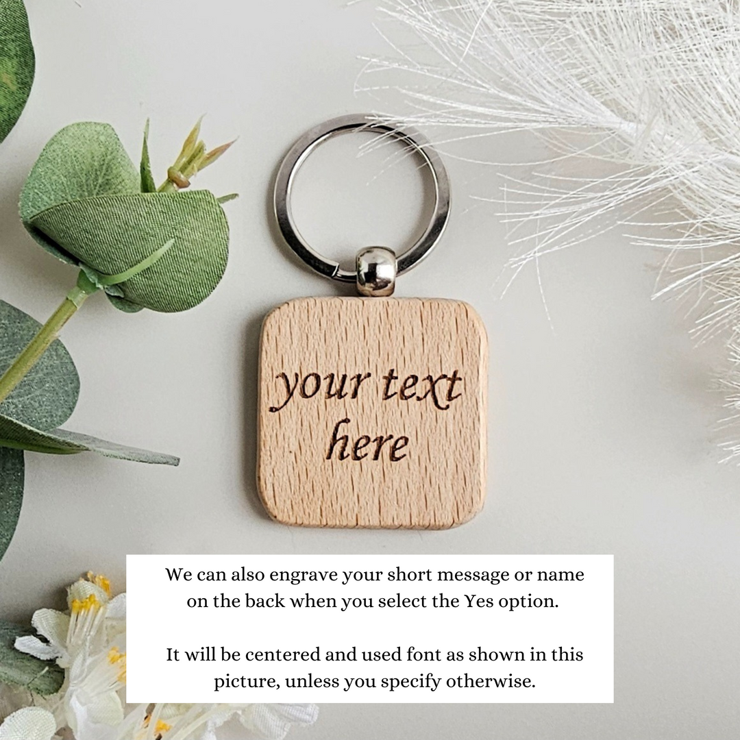 a wooden keychain with the words your text here on it