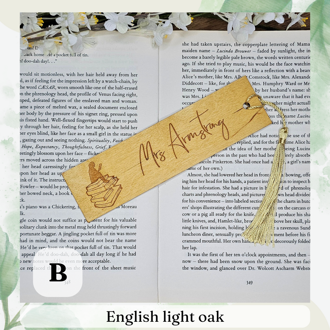 an open book with a wooden bookmark and a tassel