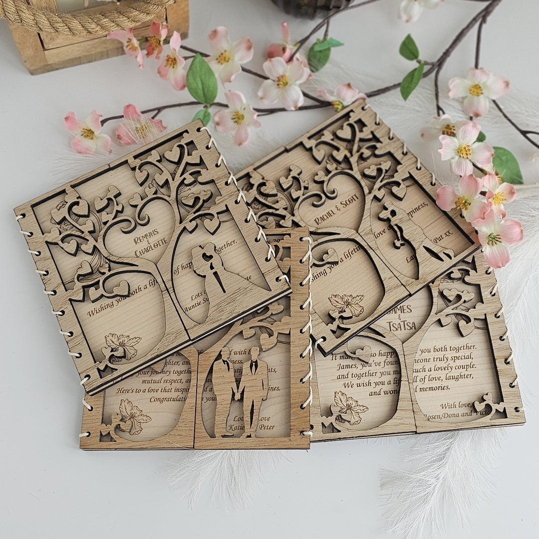 a collection of wooden wedding invitations or cards with intricate designs, placed on a white surface. The cards are adorned with floral elements and appear to be made of wood.