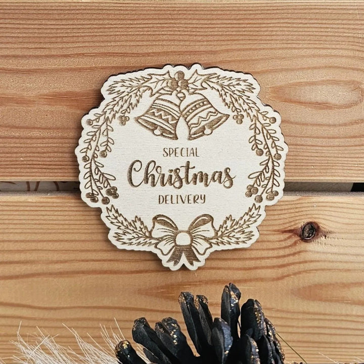 A wooden sign with the text "SPECIAL CHRISTMAS DELIVERY" and decorative elements such as bells and a wreath.