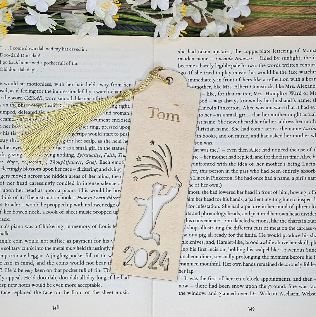 a bookmark with a tassel on top of a book