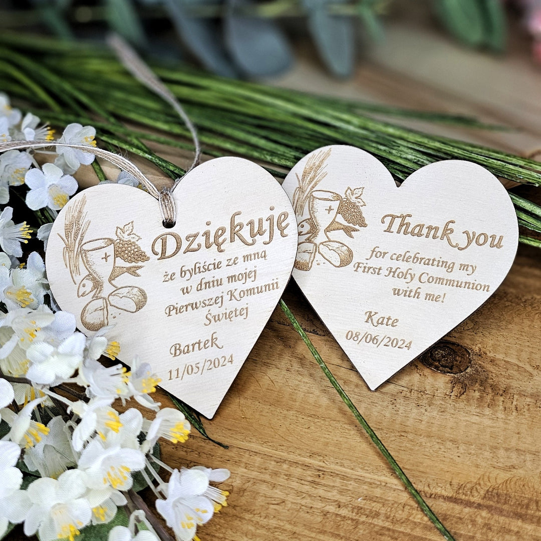 two wooden heart shaped thank you tags sitting on a table