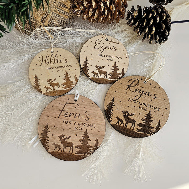 a collection of wooden ornaments with personalized names and designs, including a first Christmas ornament for each person.
