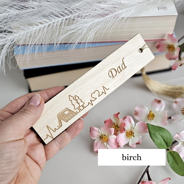 a person holding a bookmark with a name on it