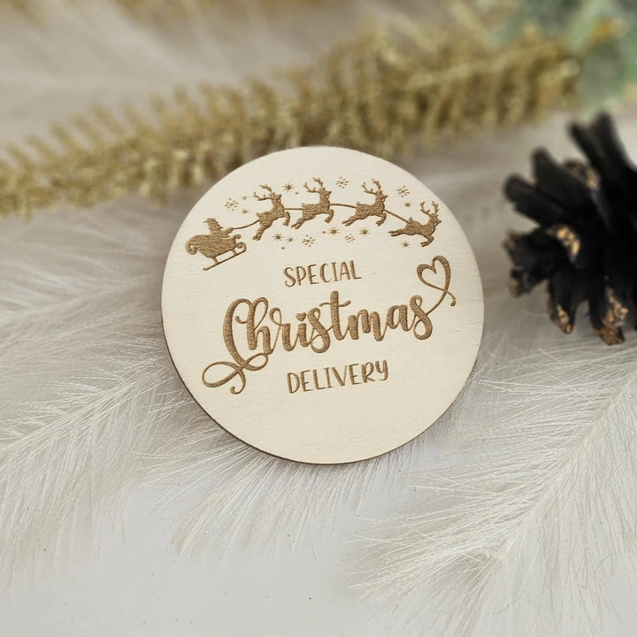 A wooden Christmas card with the text "SPECIAL CHRISTMAS DELIVERY" engraved on it, along with a silhouette of Santa Claus and reindeer.