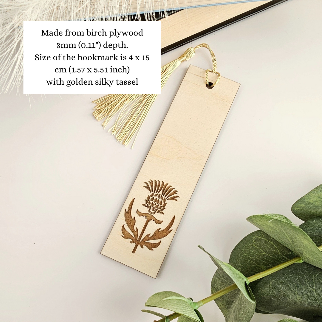 a wooden bookmark with a tassel hanging from it