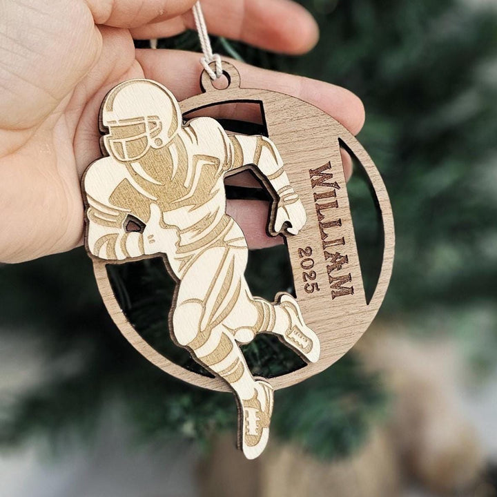 Football player silhouette ornament with custom name displayed as Christmas décor.