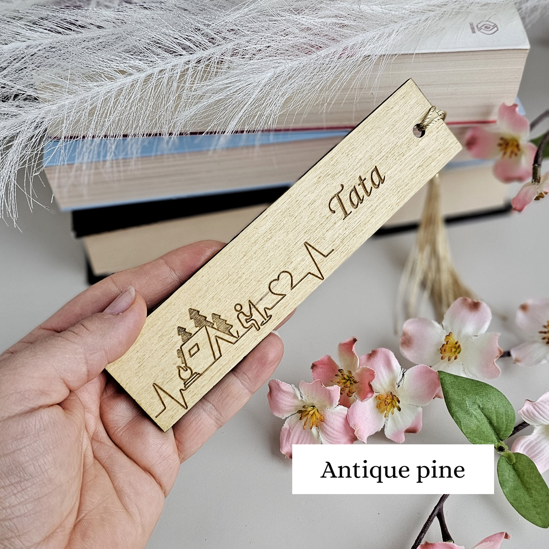 a person holding a bookmark with a name on it