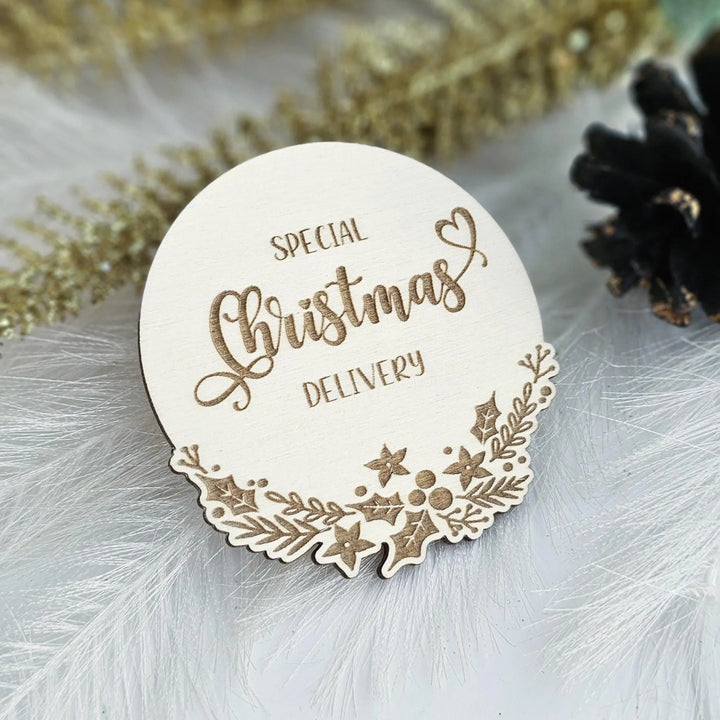 A wooden Christmas card with the text "SPECIAL CHRISTMAS DELIVERY" embossed on it, surrounded by decorative elements such as stars and leaves.