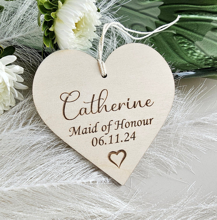 a wooden heart shaped ornament with a name on it