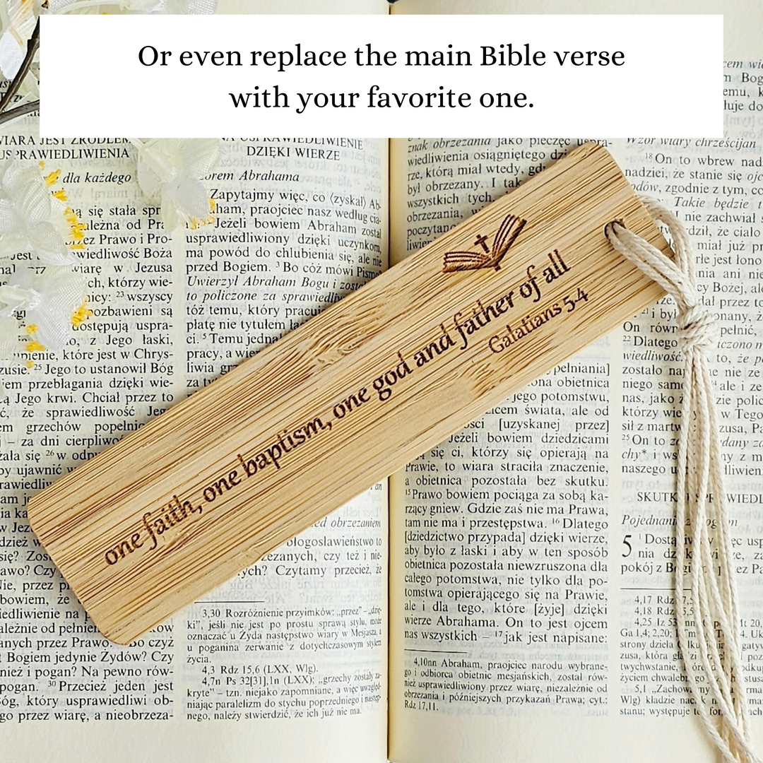 a wooden bookmark with a Bible verse engraved on it, resting on an open book with text.