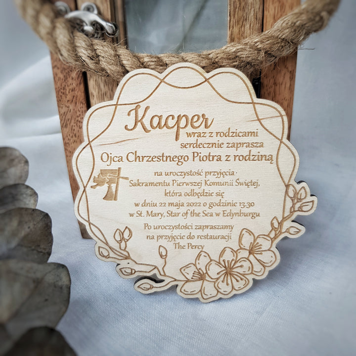 a wooden plaque with text and a decorative element, such as a flower, on a white background.