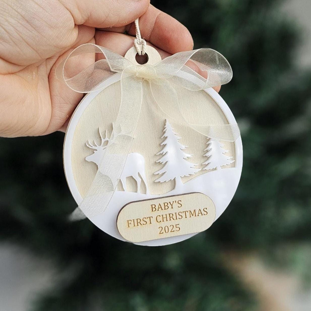 Neutral scandi style Christmas bauble held in hand.