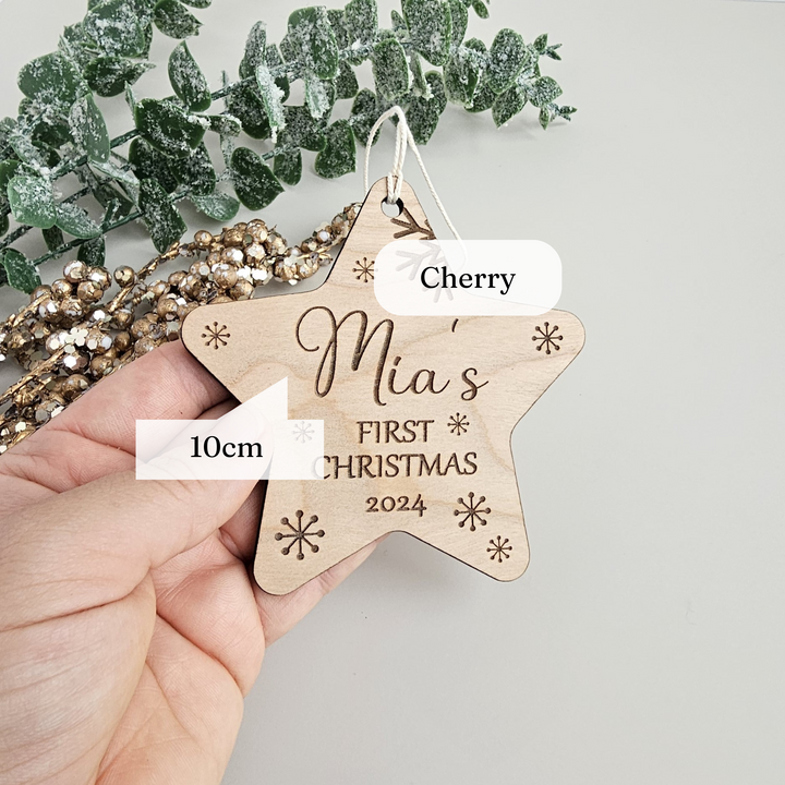 a person holding a wooden star ornament