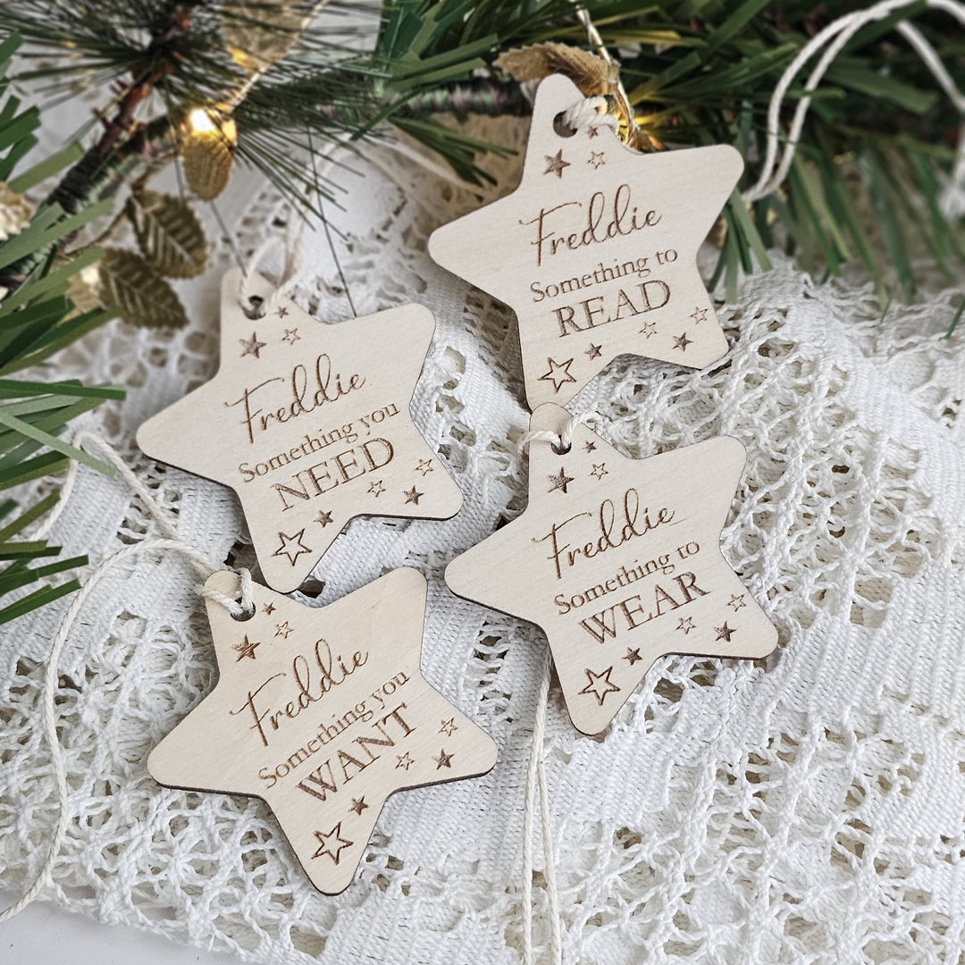 four wooden star-shaped ornaments with the text "Freddie Something to Read" written on them, placed on a lace doily.