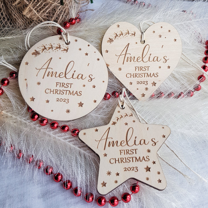 three personalized wooden christmas ornament hanging from a christmas tree