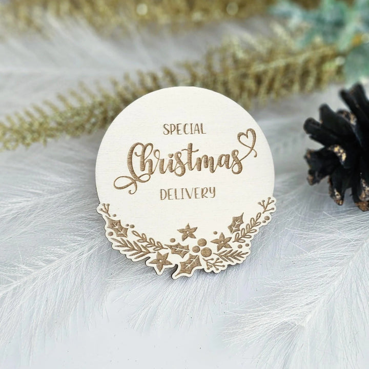 A white wooden Christmas card with the text "SPECIAL CHRISTMAS DELIVERY" on it, surrounded by decorative elements such as leaves and stars.