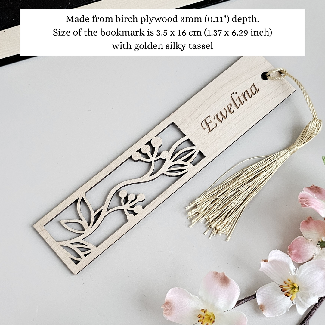 a wooden bookmark with a flower and a tassel