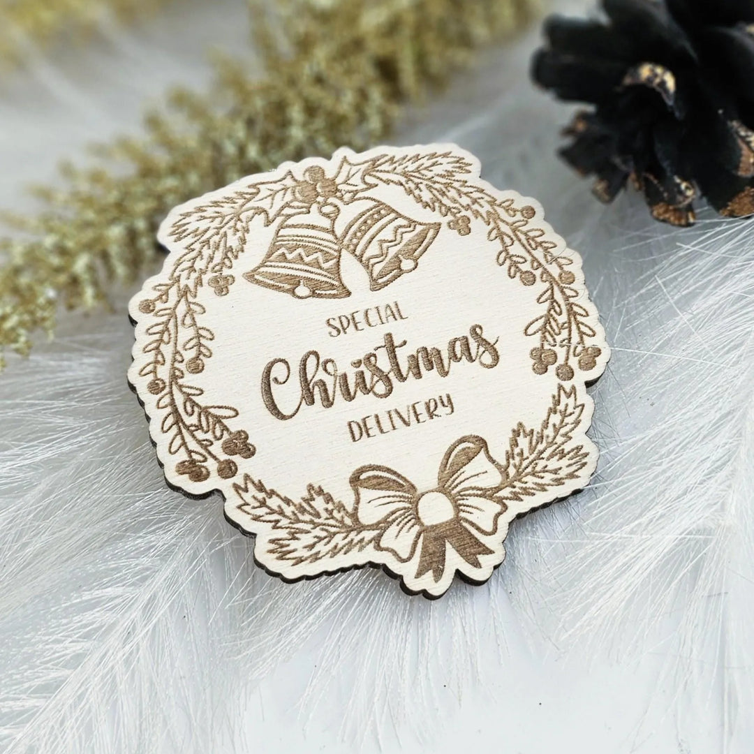 A wooden Christmas card with the text "SPECIAL CHRISTMAS DELIVERY" embossed on it, surrounded by a wreath and bells.