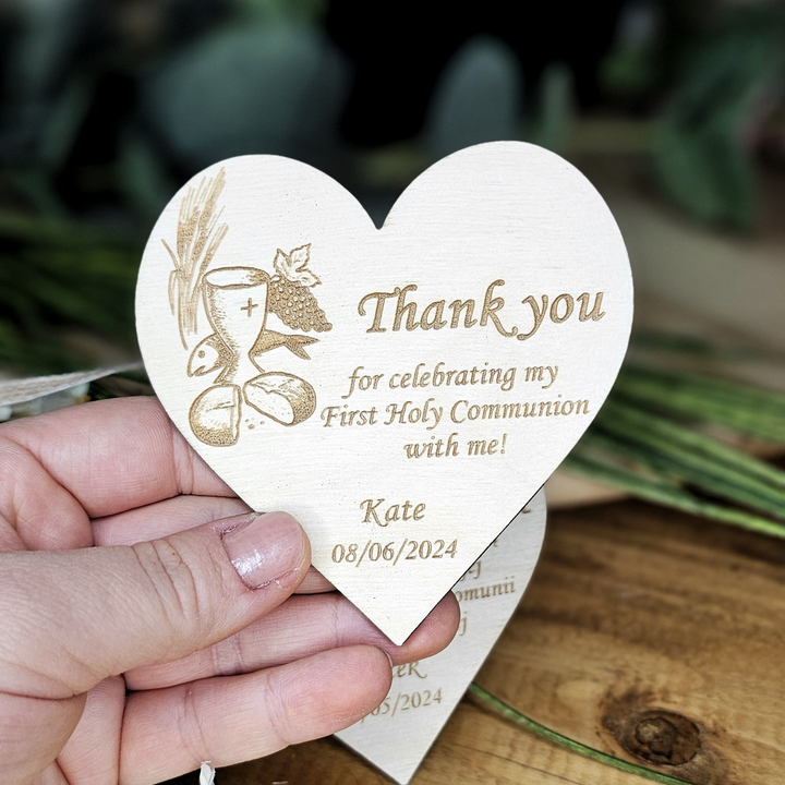 a person holding a wooden heart shaped card