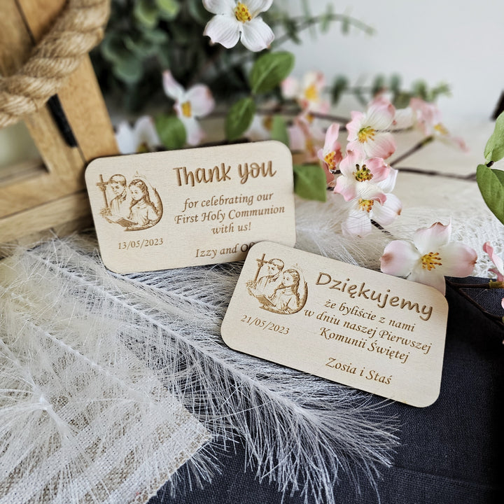 two wooden business cards sitting on top of a table