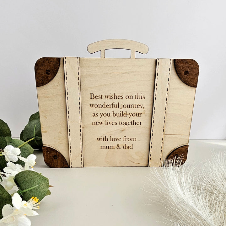 a wooden suitcase with a quote on it