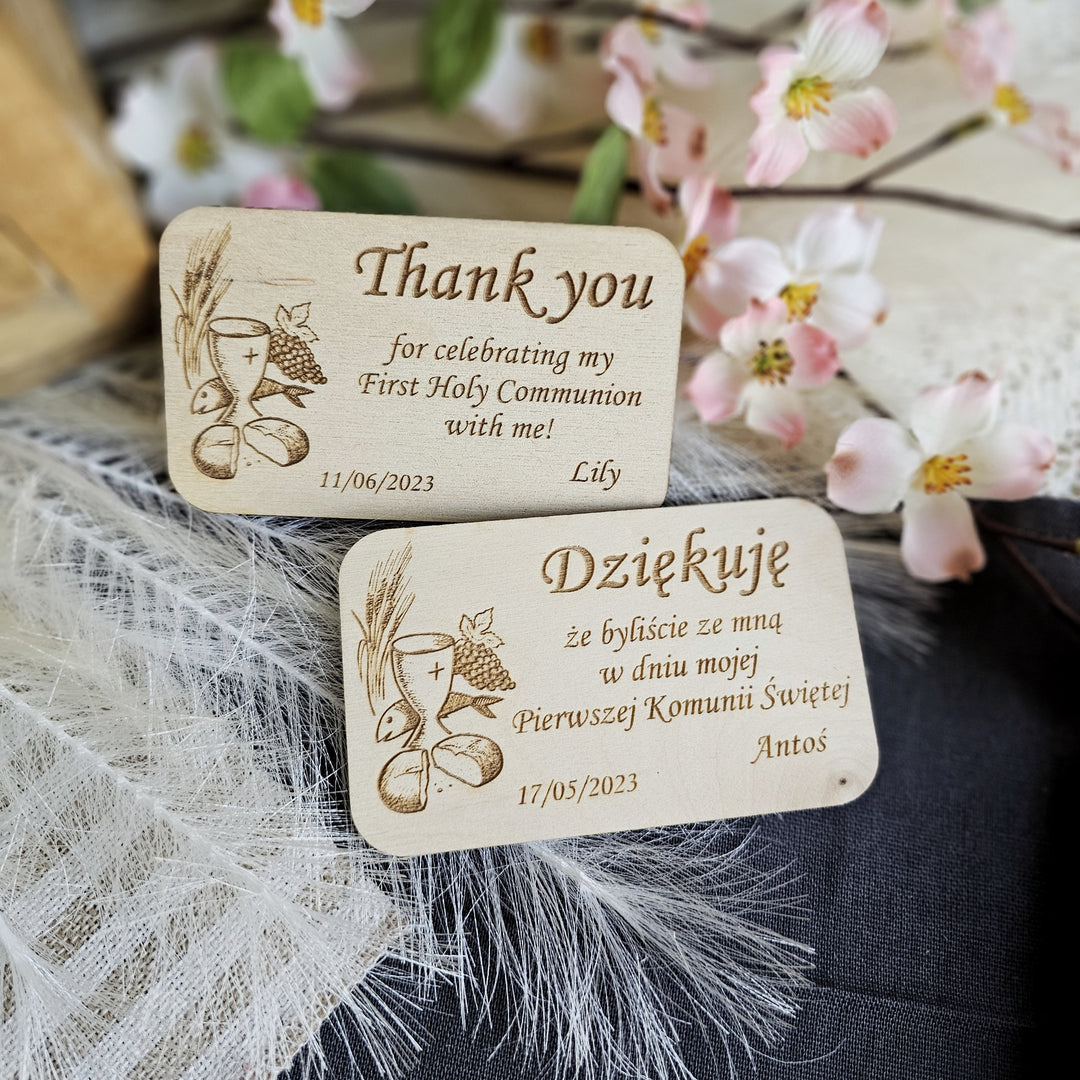 two wooden business cards sitting on top of a table