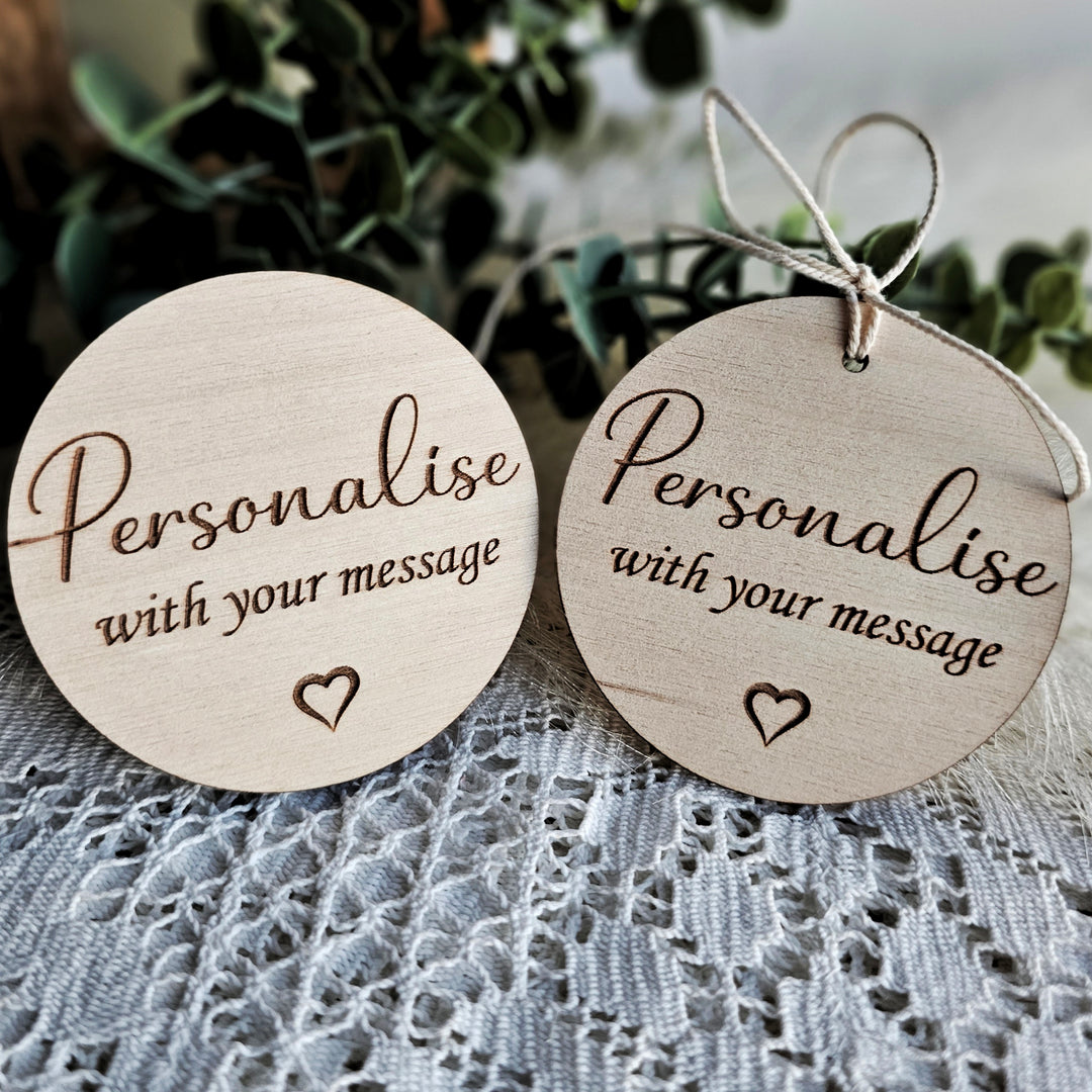 two personalized wooden tags on a table