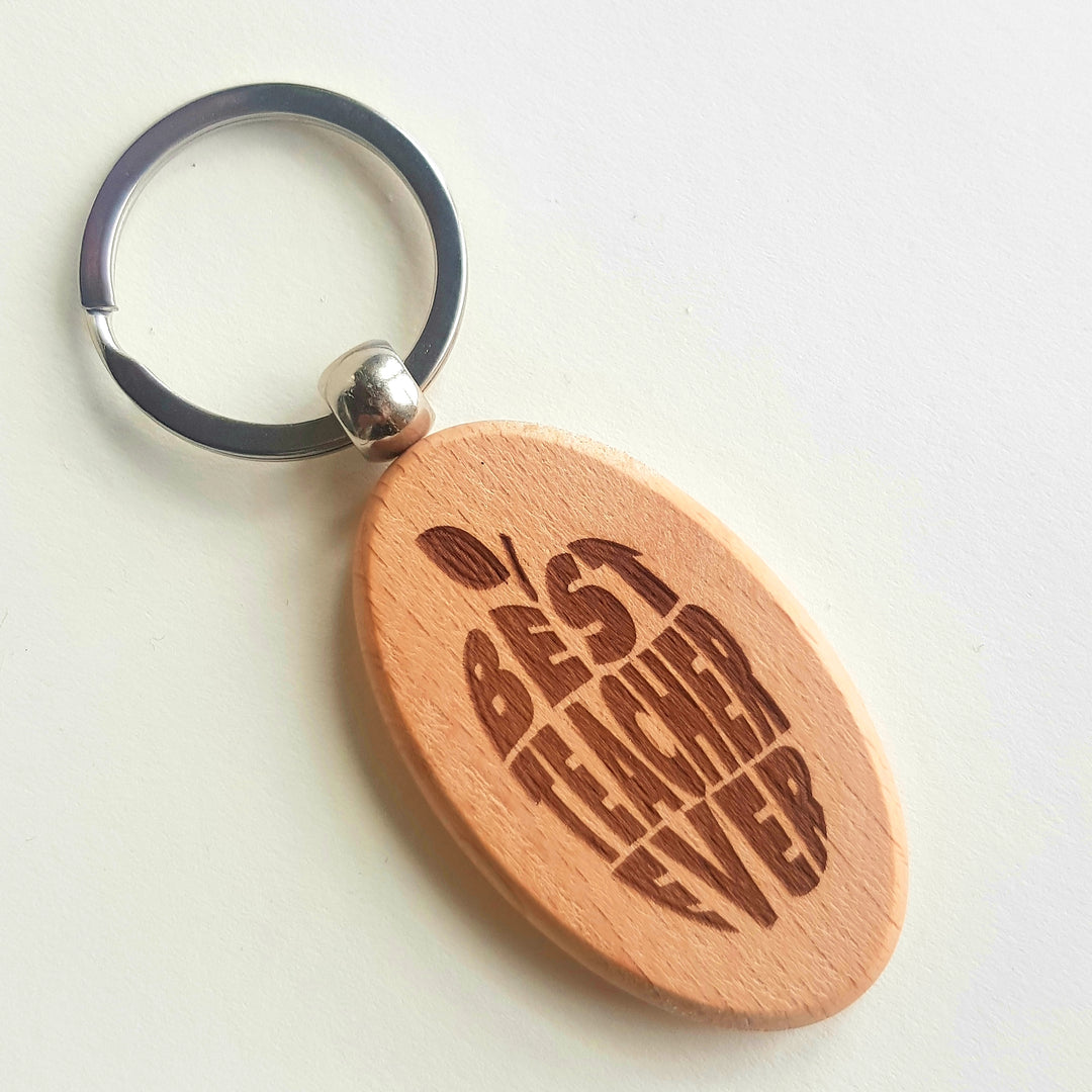 a wooden keychain with a picture of a baseball bat and ball on it