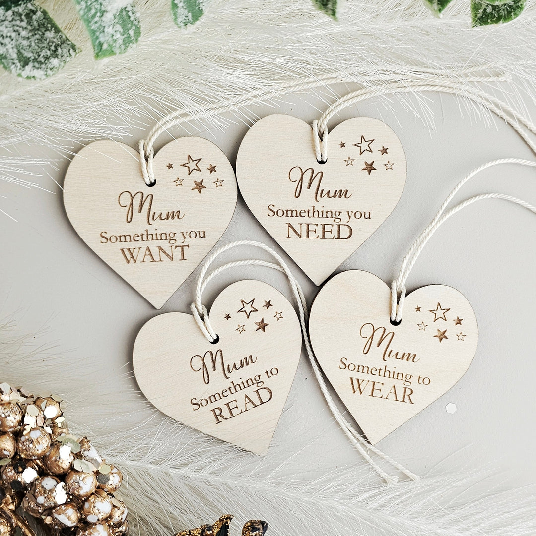 four wooden heart shaped tags hanging from a string